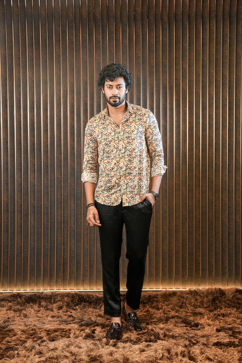 Luxury men’s resort wear silk shirt with relaxed tailoring, styled with black trousers for refined casual and travel dressing