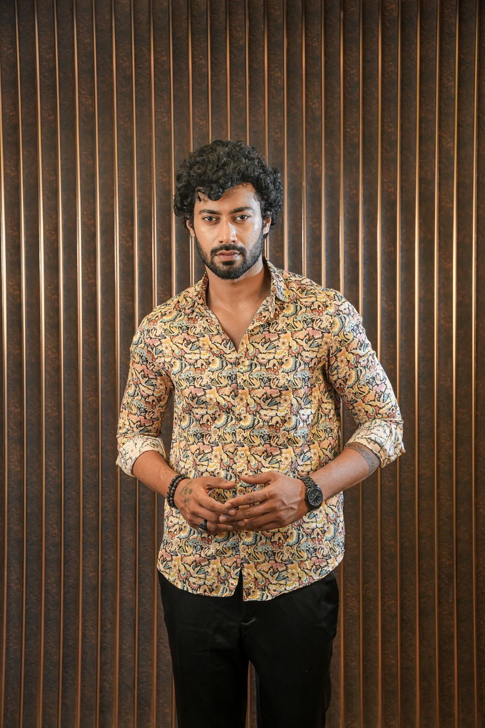 Luxury men’s resort wear silk shirt with relaxed tailoring, styled with black trousers for refined casual and travel dressing