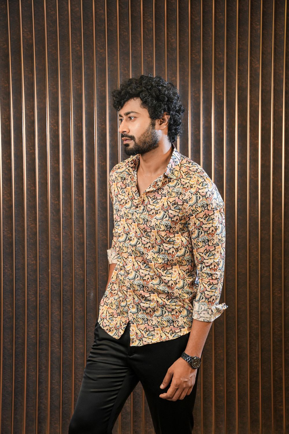 Luxury men’s resort wear silk shirt with relaxed tailoring, styled with black trousers for refined casual and travel dressing